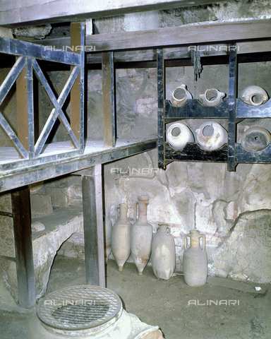 AGC-F-000227-0000 - The entrance to the house of Neptune and Amphitrite in Herculaneum. In the foreground the original shelves used to keep the wine amphoras. Other amphoras are on the ground - Date of photography: 1989 - Reproduced with the permission of Ministero della Cultura / Alinari Archives, Florence