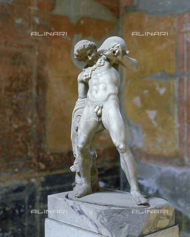 AGC-F-000230-0000 - Marble statue of a satyr with a wineskin on his left shoulder. The small statue is in the house of the Deer in Herculaneum - Date of photography: 1989 - Reproduced with the permission of Ministero della Cultura / Alinari Archives, Florence