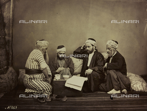 AVQ-A-001581-0040 - Album " Damas et Baalbek ": A group of Syrians sitting around a table - Date of photography: 1880 ca. - Alinari Archives, Florence