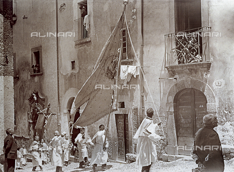 BAQ-F-001323-0000 - Processione della Madonna del Carmine a Scanno: un gruppo di laici in vesti bianche procede lungo la via con un alto stendardo ed un crocifisso - Data dello scatto: 16/07/1910 - Archivi Alinari, Firenze