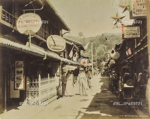 FVQ-F-151936-0000 - A street in Nagasaki with Western people, parked rickshaws and photo shop "T. Shirayama", Japan - Date of photography: 1885-1895 - Alinari Archives, Florence