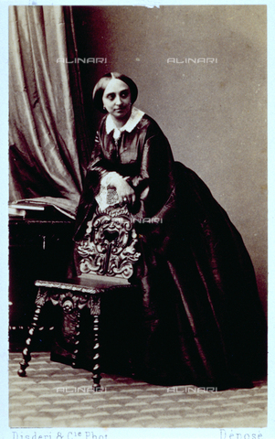 MFC-F-000978-0000 - Portrait of a woman in elegant day dress. She is standing, leaning on a chair - Date of photography: 1854-1860 ca. - Alinari Archives, Florence