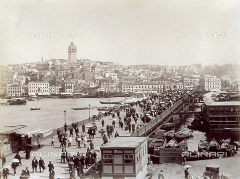 PDC-A-004568-0014 - The Galata Bridge which joins the two parts of the city of Istanbul separated by the Golden Horn. The bridge is crowded with people. In the background the city with the Galata Tower - Date of photography: 1870-1875 ca. - Alinari Archives, Florence