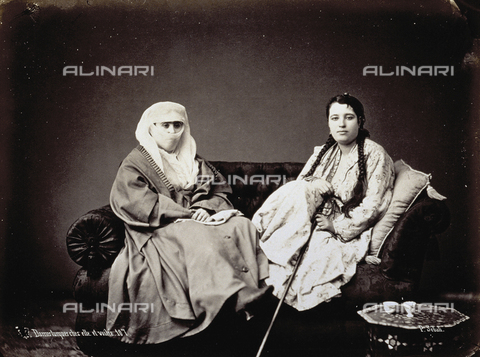 PDC-A-004568-0021 - Portrait of two turkish women in traditional clothing. One of them is wearing the chador. They are seated on a sofa - Date of photography: 1870-1875 ca. - Alinari Archives, Florence