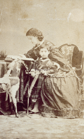 PDC-F-000612-0000 - Portrait of Eugenie Attendolo Bolognini Litte in day dress, sitting at a table, while reading a book, and of the young Pompeo Litte, her son - Date of photography: 1854-1864 ca. - Alinari Archives, Florence