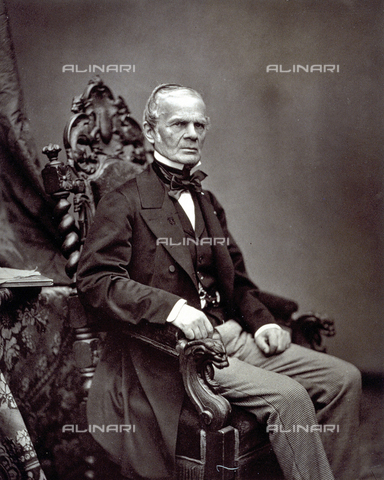 PDC-S-000030-0003 - Portrait of the writer Cuvillier-Fleury seated on a ornately carved wooden chair. On his right a flowered cloth and a few books - Date of photography: 1860 -1865 ca. - Alinari Archives, Florence