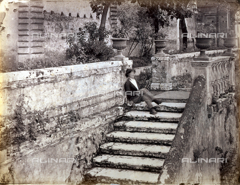 PDC-S-000461-0011 - A man sleeping seated on a staircase. Behind him trees and the walls of a building can be glimpsed - Date of photography: 1870-1890 ca. - Alinari Archives, Florence