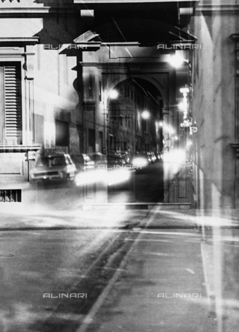 VZA-F-000036-0000 - A double exposure of two images, one of a doorway and the other of a street at night, cars passing with headlights on - Date of photography: 1950-1960 ca. - Alinari Archives, Florence